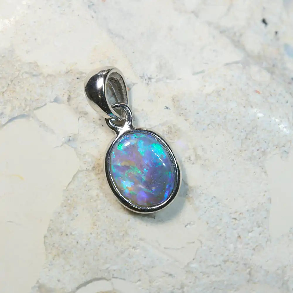 Lightning Ridge solid opal pendant in sterling silver, showcasing vibrant green and blue hues.