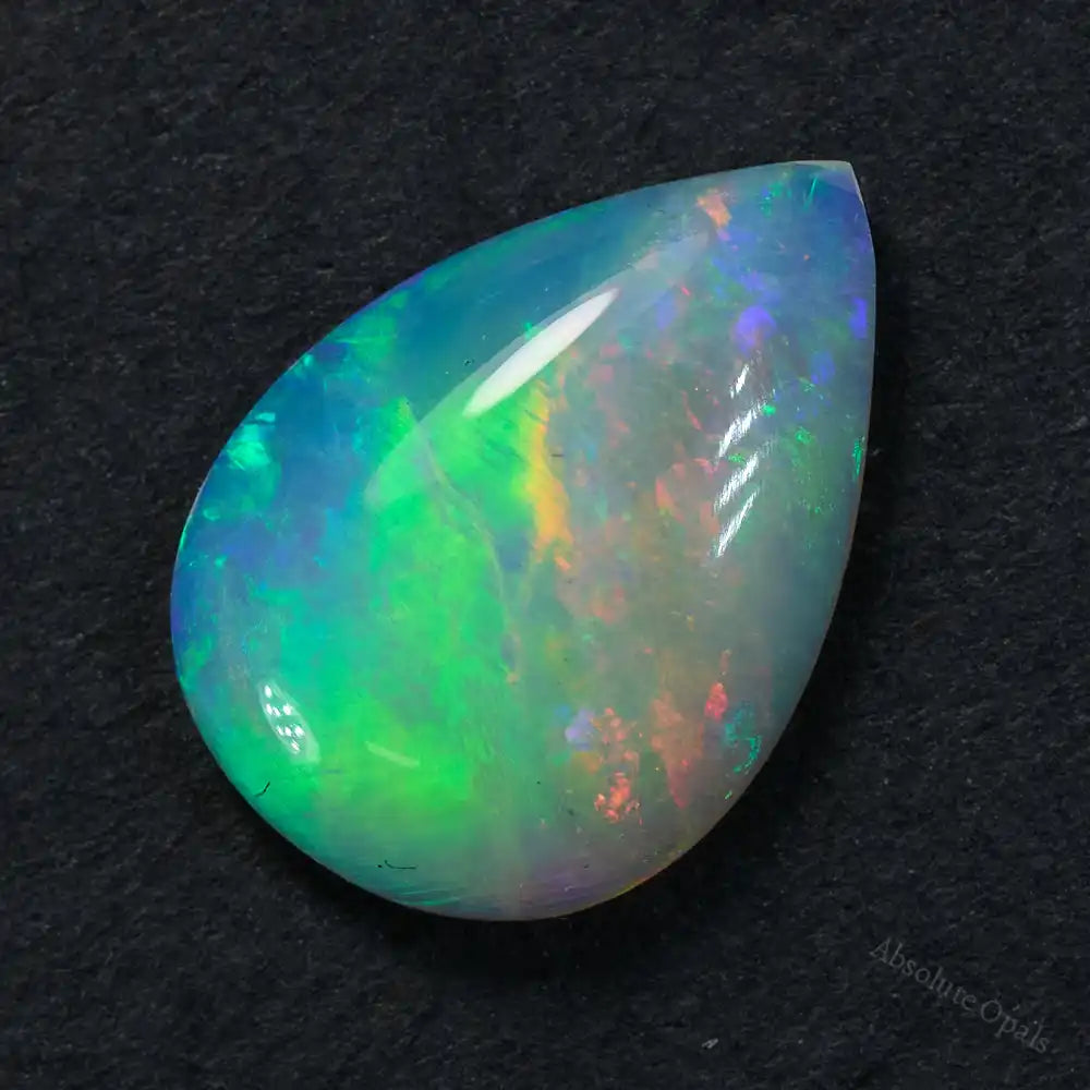 0.88 cts South Australian opal solid stone crystal, teardrop cut with vibrant orange, yellow, and green colors.