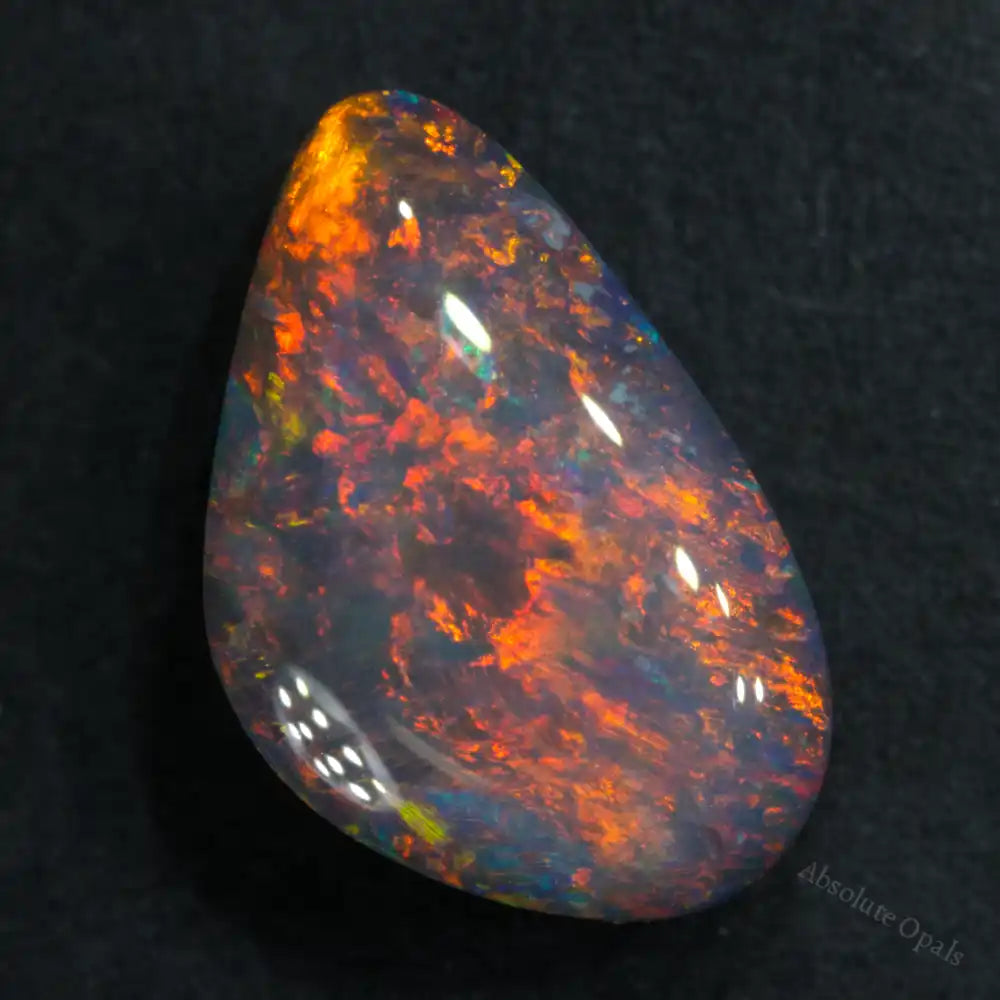 1.86 cts Black Opal from Lightning Ridge, teardrop shape with vibrant dark orange and red colors.