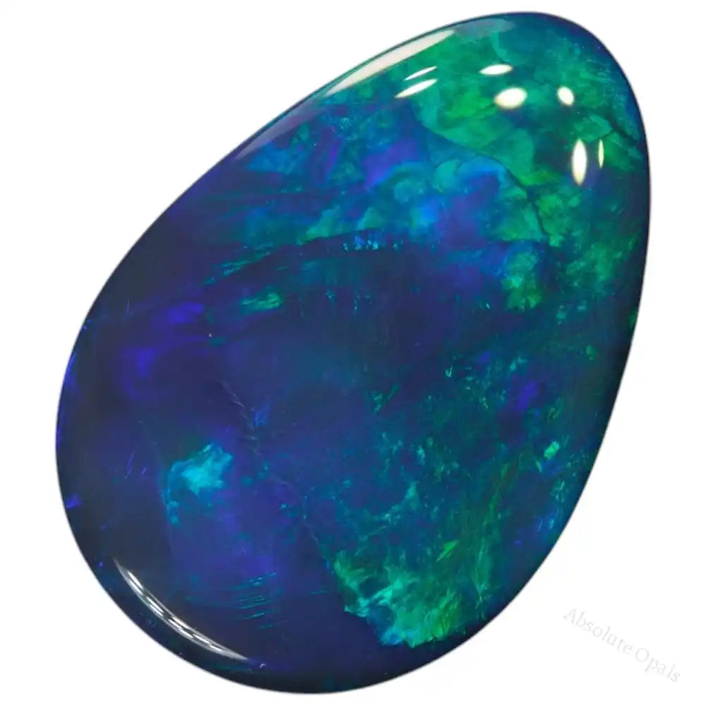 Natural solid black opal from Lightning Ridge, cut in a smooth green cabochon shape, featuring vivid play-of-color