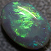 5.02 carat black opal with green and blue hues from Lightning Ridge, oval cabochon shape.