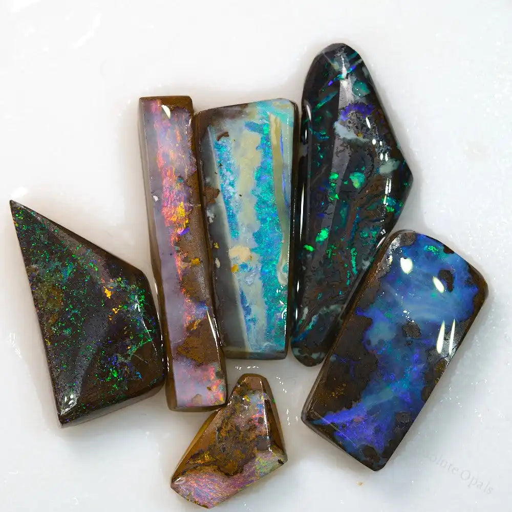 Boulder opal rough stones in vibrant red, green, and multi-colors, ideal for pendants, weighing 56.4 cts, from Queensland, Australia.