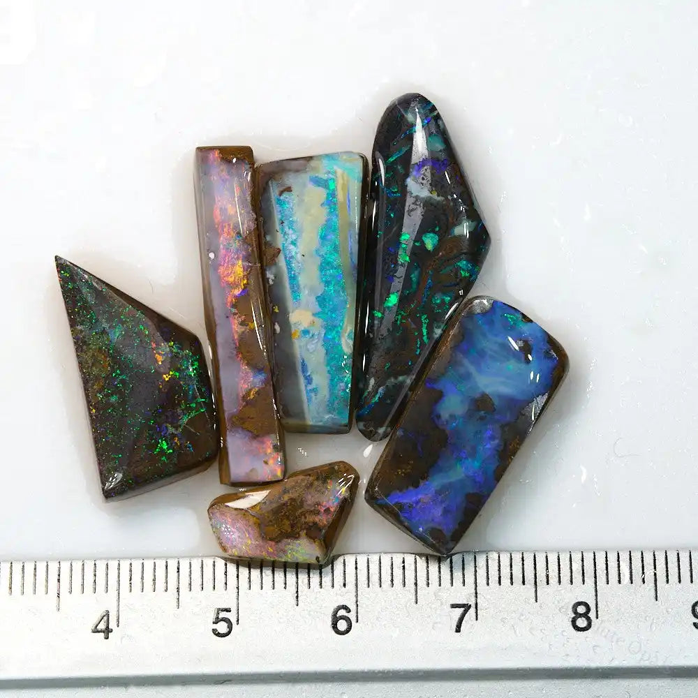 Boulder Opal Rough Parcel Rubs – Australian Natural Opals
A hand-selected parcel of rough Boulder Opals from Queensland, featuring bright color bars and strong potential for cutting. These rubs are partially pre-shaped and ready for lapidary or collectors. 100% natural, untreated material.