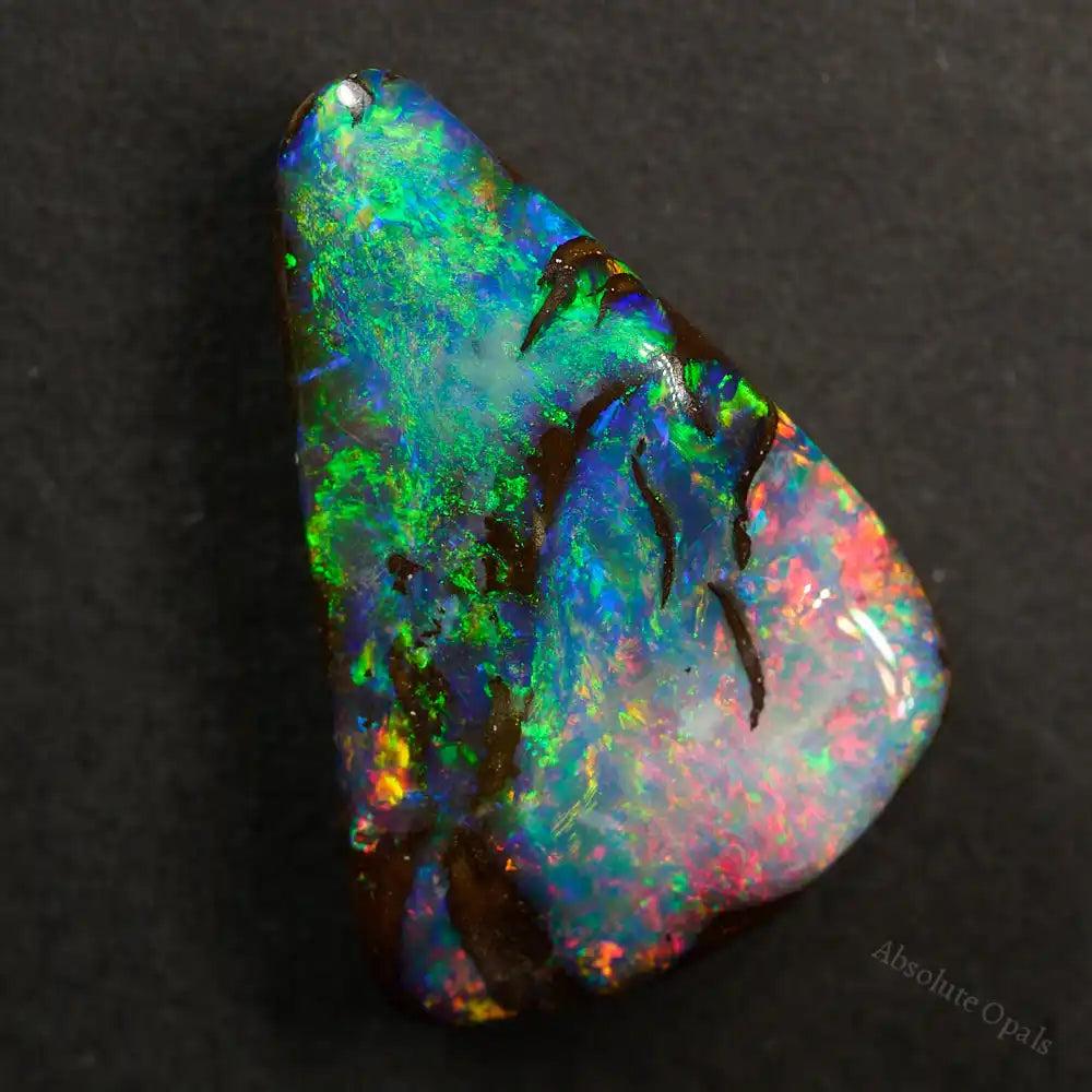 9.62 cts Boulder Opal cut stone showcasing vibrant red and green colors with stunning flashes of blue and purple.