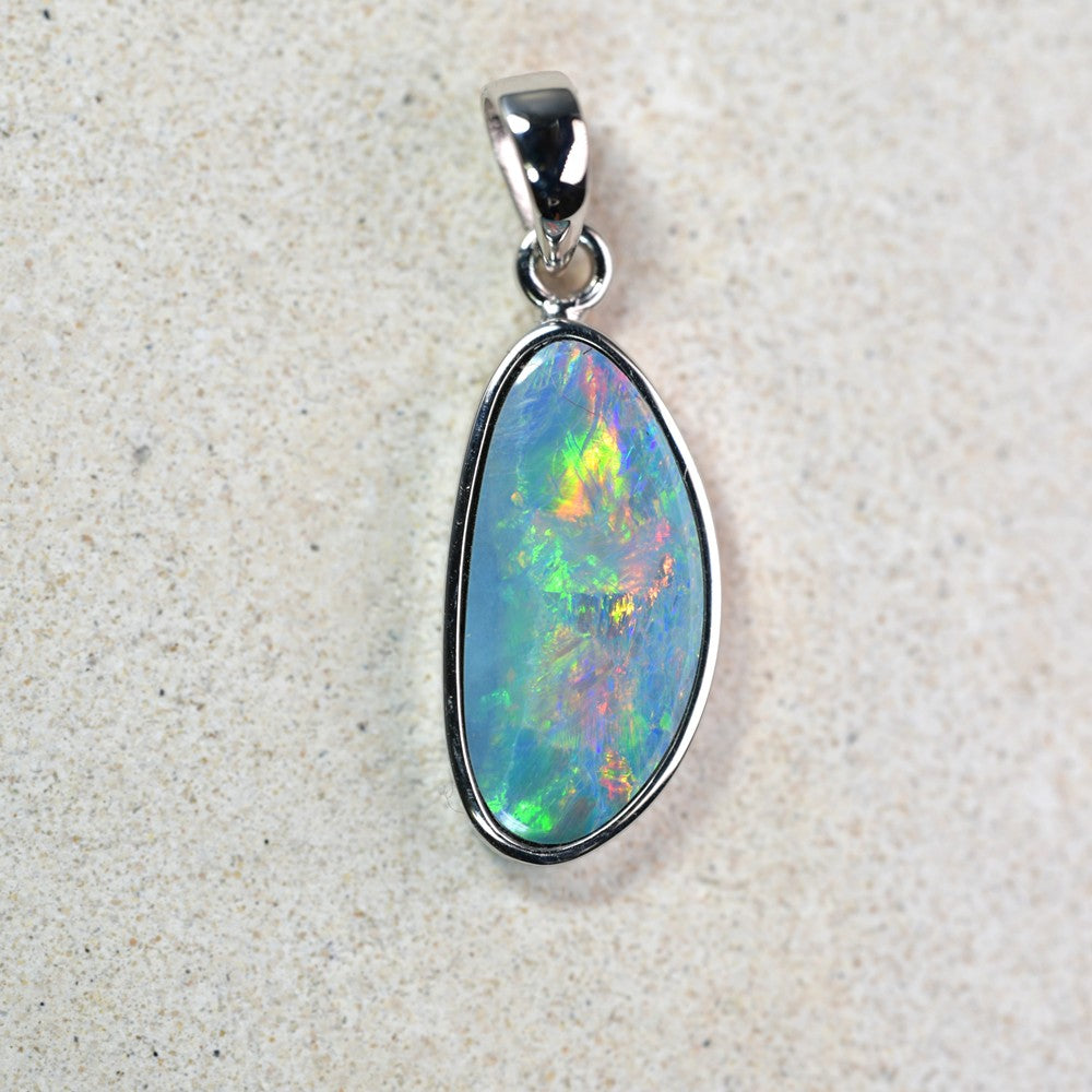 Australian opal doublet pendant set in 14K gold, showcasing vibrant play-of-color. Elegant and timeless jewelry piece, perfect for opal lovers and collectors