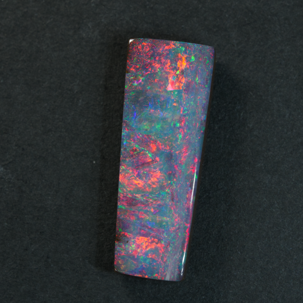 4.52 cts Boulder Opal cut stone featuring vibrant red and multi-colour hues, showcasing Australian craftsmanship.