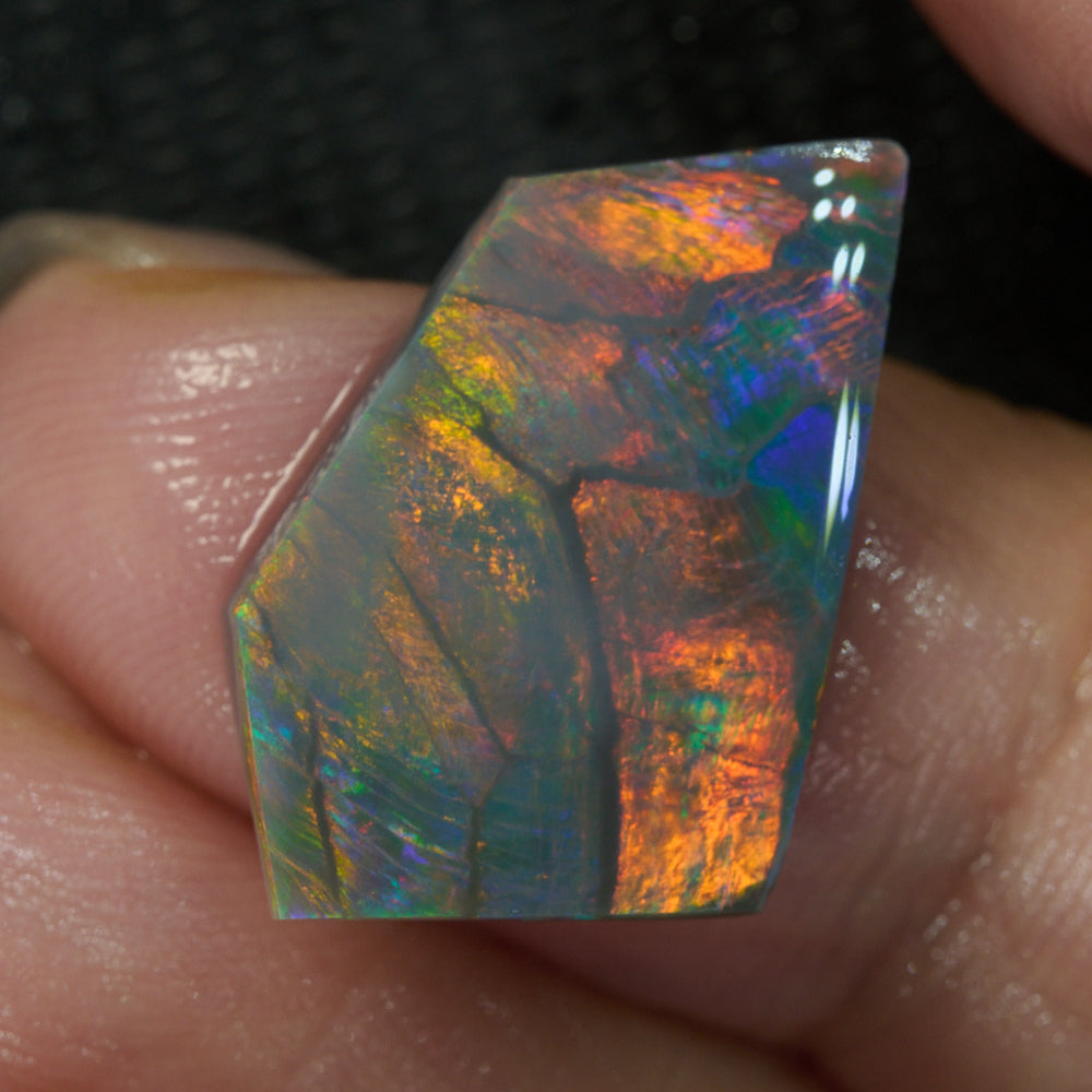Uncut Lightning Ridge opal rub showing vivid red flashes – premium rough opal from Australia
