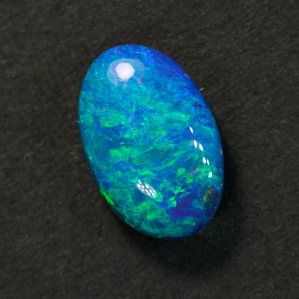 0.83 cts Australian Doublet Opal stone from Lightning Ridge, vibrant green and blue oval gemstone.