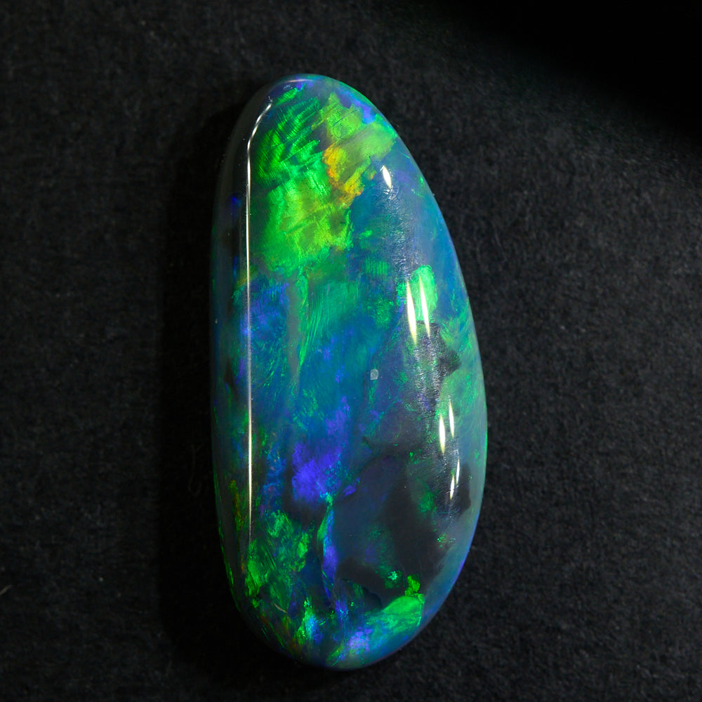 1.89 cts Black Opal Lightning Ridge with vibrant orange and green hues, low dome F-form shape.