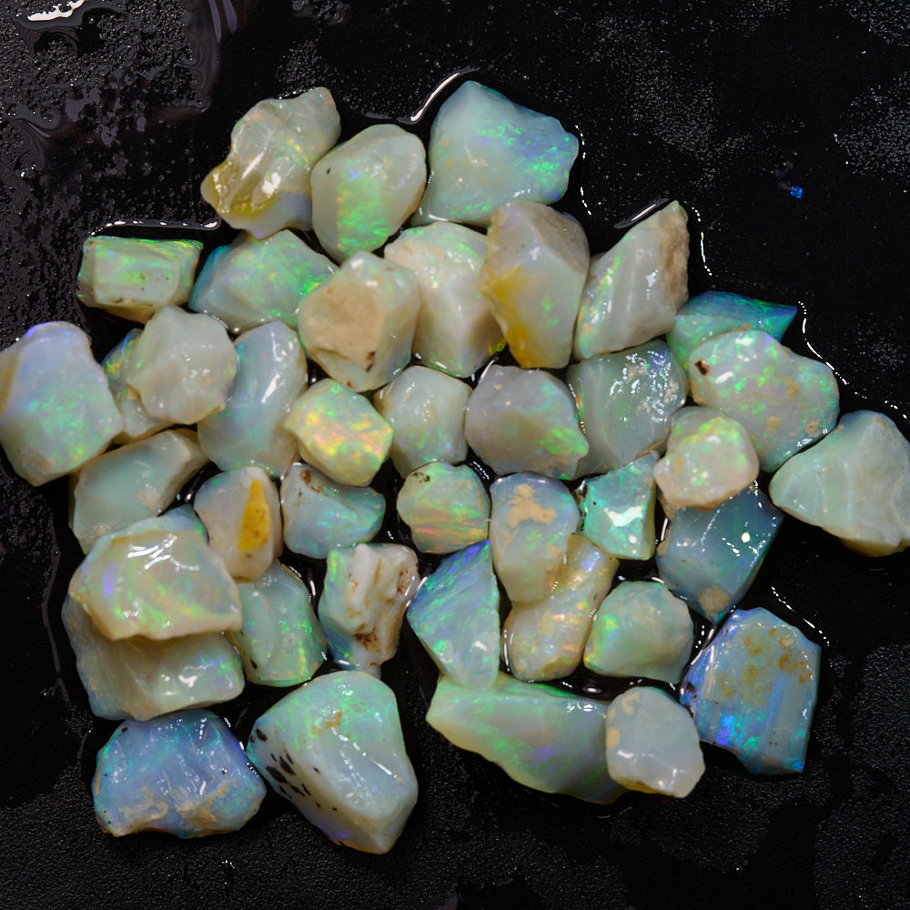 Rough opal chips in light green and multi-color hues, perfect for inlay and mosaic projects, weighing 50 cts.