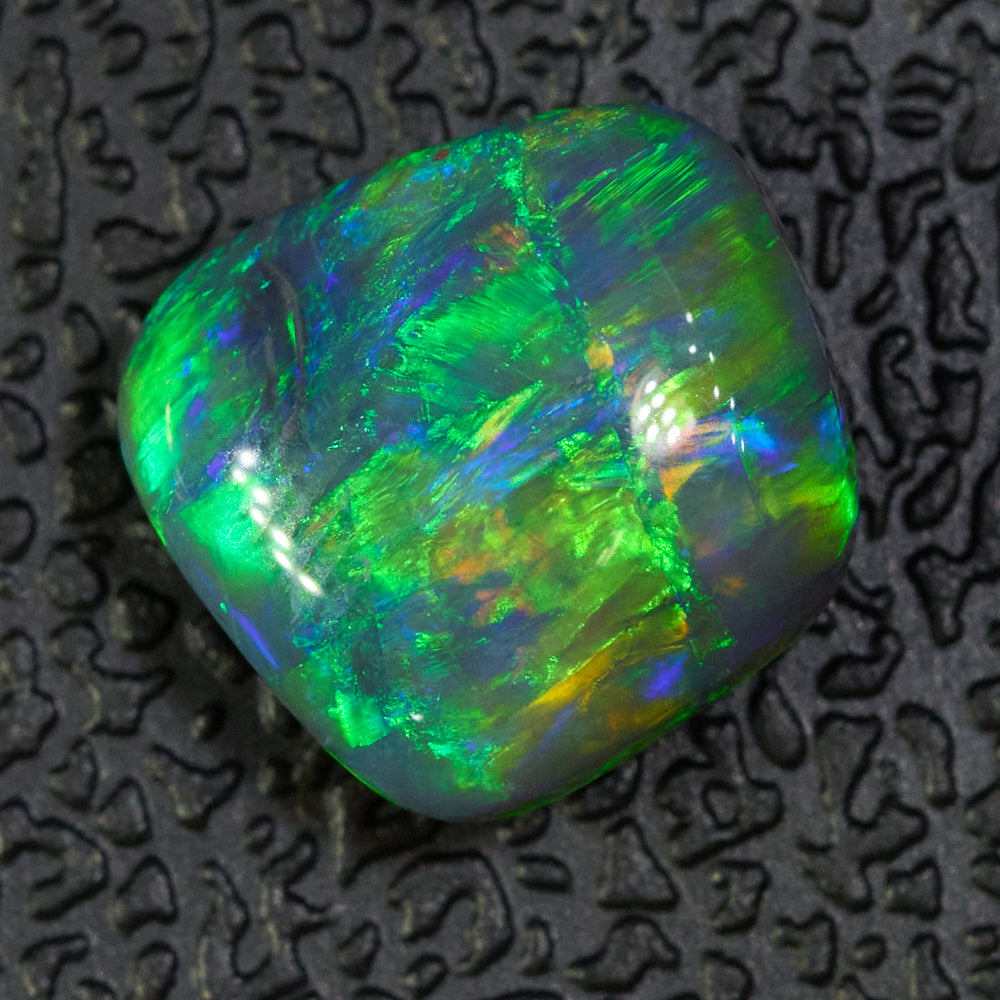 1.75 cts Black Opal from Lightning Ridge displaying vibrant green and orange colors with high dome shape.