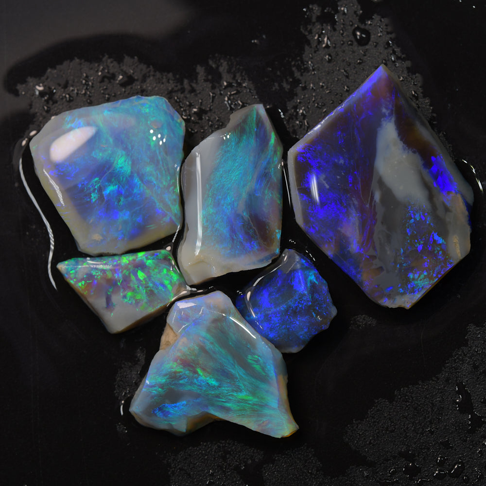 Australian Lightning Ridge rough black opal parcel featuring opal rubs and offcuts with natural colour flashes, suitable for cutting, polishing, inlay work, lapidary projects, and collecting