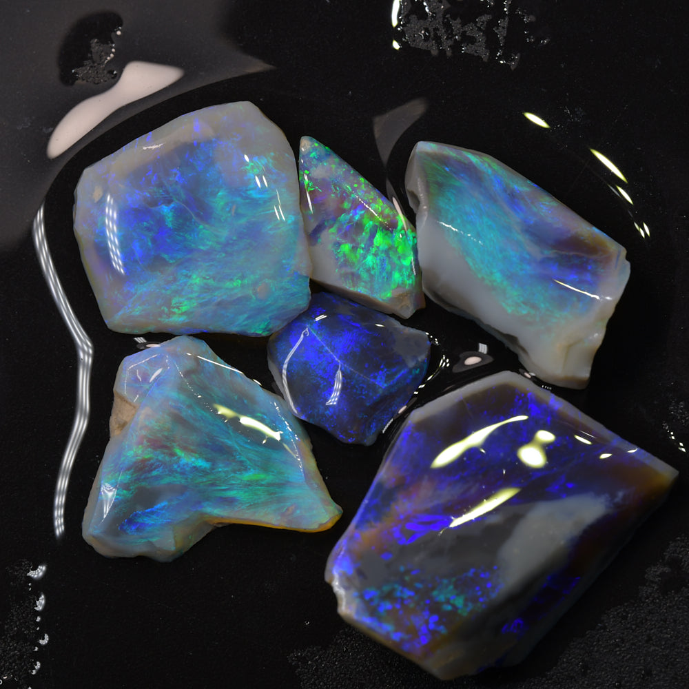 Lightning Ridge black opal rubs and offcuts with natural colour.