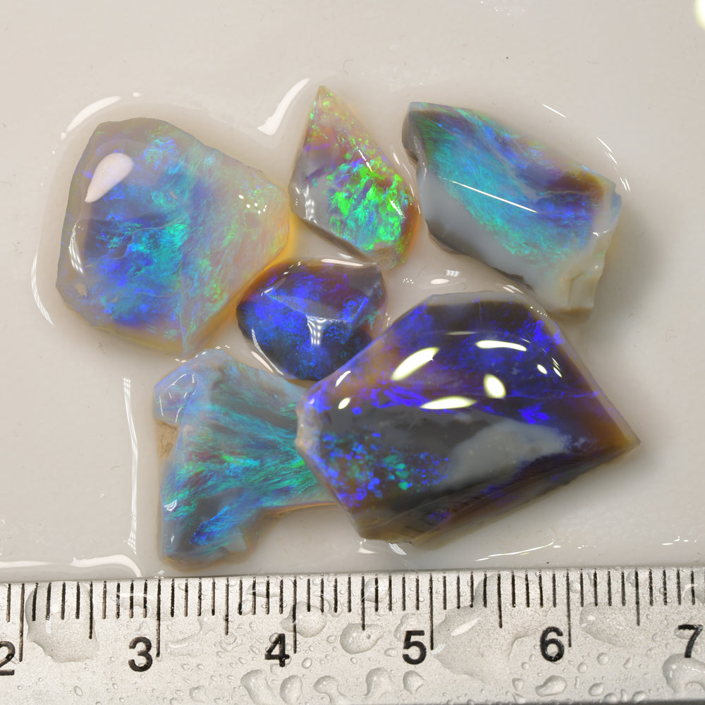 Rough black opal parcel from Lightning Ridge, Australia, containing opal rubs and offcuts with natural colour and lapidary potential