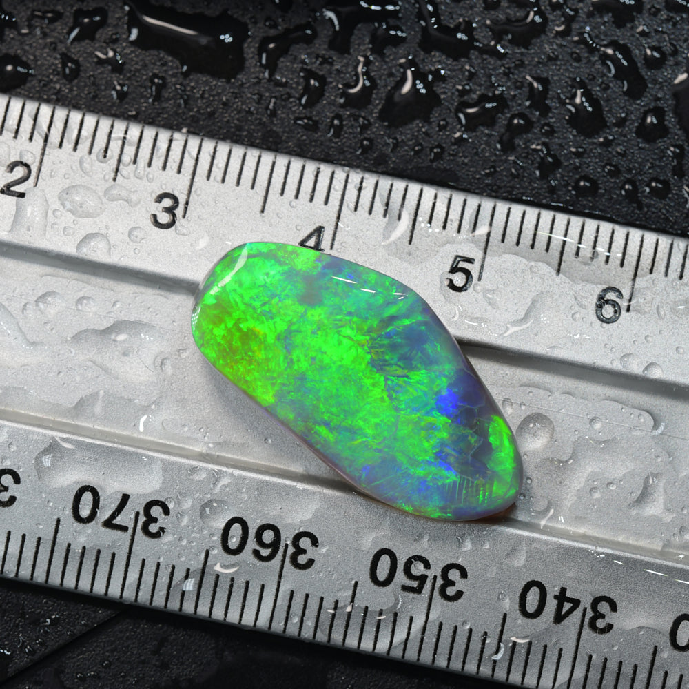 Lightning Ridge rough opal rub from Australia displaying vibrant green flashes of natural colour with excellent cutting potential