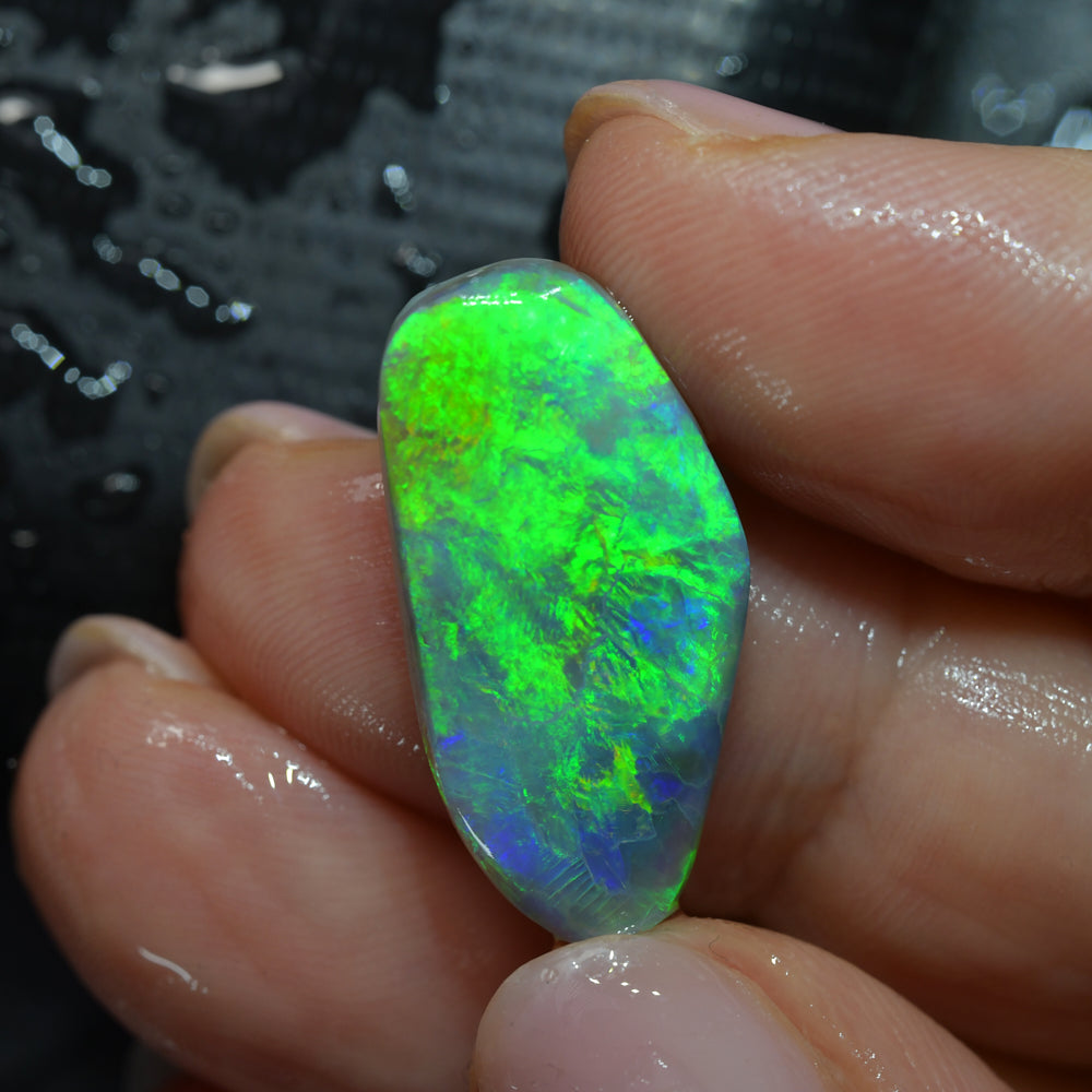 Natural Australian Lightning Ridge rough opal rub featuring vivid green colour flashes, ideal for cutting, polishing, lapidary work, jewelry making, and collecting