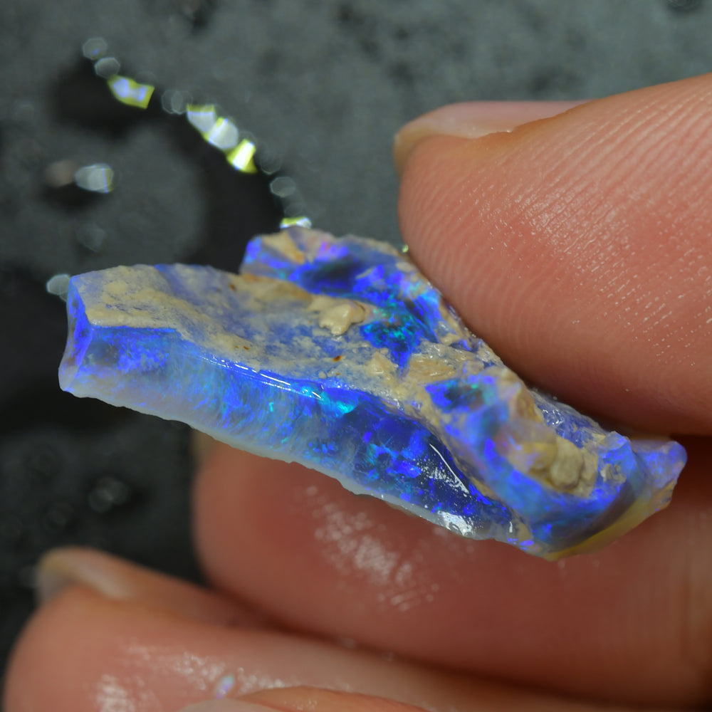 Australian Lightning Ridge rough black opal carving featuring natural colour flashes, unique carved opal artwork, and collectible gemstone appeal