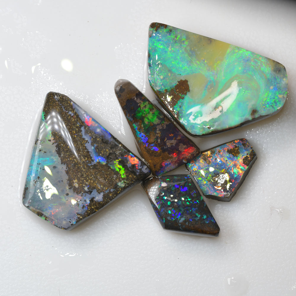 Australian boulder opal rough parcel rubs featuring vivid red and green colour flashes, ideal for cutting, polishing, lapidary work, and gemstone collecting