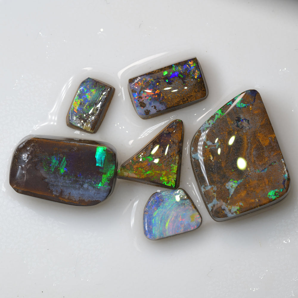 Australian Lightning Ridge rough black opal carving featuring natural colour flashes, unique carved opal artwork, and collectible gemstone appeal