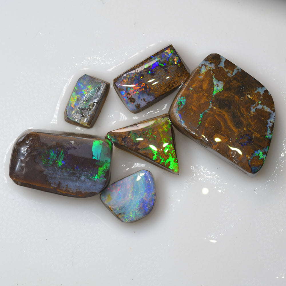 Rough black opal carving from Lightning Ridge, Australia, featuring natural colour and hand-carved opal material