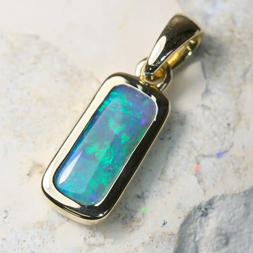 Genuine opal pendant set in 14K gold showcasing vibrant green hues from Lightning Ridge.