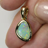 Elegant South Australian opal pendant in 14K gold shown on model – genuine solid opal with shimmering colors.