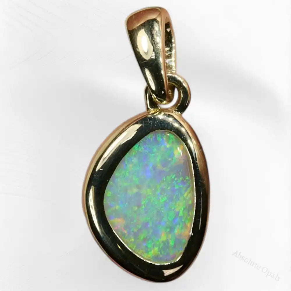 Close-up of genuine South Australian solid opal pendant set in 14K gold – natural play of color with vibrant flashes.