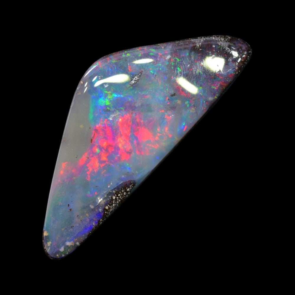 Boulder opal cut stone from Australia displaying natural colour play within its ironstone host rock