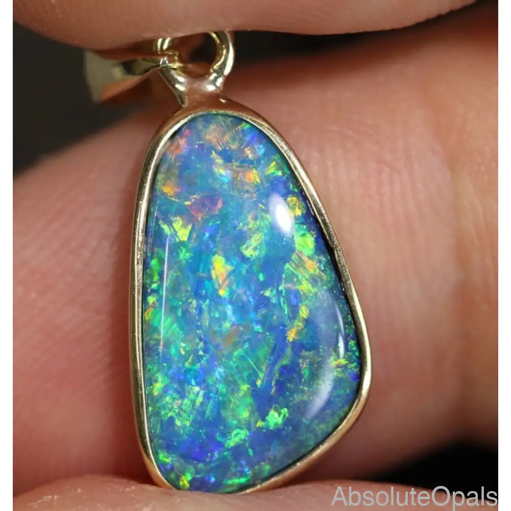 Australian doublet opal pendant in 14k gold, vibrant blue, green, and red hues, 23.8mm length.